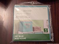 Front packaging view showing product name, size, and color (sky blue).