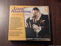 Front cover of the Louis Armstrong 4 CD set titled 'Hot Fives and Sevens' featuring a photo of Louis Armstrong with trumpet and box set details