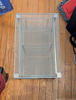 Top view of rectangular metal mesh organizer showing mesh bottom and sides.