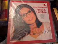 Front cover of Nana Mouskouri LP Roses & Sunshine showing clear image of signed autograph on cover.