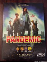 Front cover of the Pandemic board game box showing characters and game title.