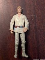 Front view of Luke Skywalker action figure showing detailed face, cream-colored outfit, and articulated joints.