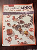 Front cover of the book 'Essential Links for Wire Jewelry' 2nd Edition showing detailed images of wire jewelry links.