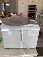 White Black & Decker All-in-One Horizontal Breadmaker viewed from the front with power cord visible.