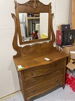 Front view of the dresser with attached mirror showing overall condition and design.