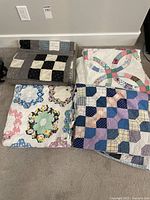 All four quilts folded and laid out