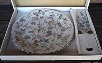 Full view of the cake plate and server set in original box with floral pattern and gold trim