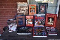 Photo of 11 assorted baseball books including titles from ESPN Baseball Encyclopedia, Red Sox Nation, Ted Williams Biography, Stephen King Pop-Up book, and others
