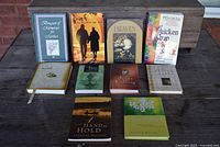 Full view of all 10 inspirational books arranged in two rows with a mix of hard and soft cover books showing titles and covers