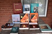Books arranged on table showing variety of science and geology titles including The Human Body, Structural Geology, and General Chemistry showing cover conditions and titles.