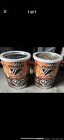 Photo showing two unopened metal cans of Penefin wood stain and sealer with beige labels.