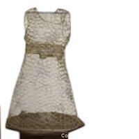 Front view of wire mesh dress sculpture on a solid round base