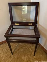 Front view with hinged lid open showing velveteen interior and lid hinges