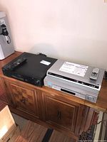 Photo showing Sony SLV-N700 VHS recorder (silver front) stacked on Panasonic DVD player DVD-S29 (silver) and Sony SLV-920 HF VHS recorder (black) next to them