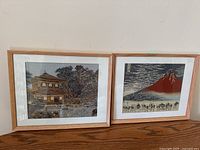 Two framed fabric art pieces side by side, showing overall size and framing style.