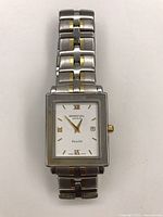 Overhead view showing full watch with two-tone bracelet and square case