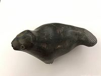 Side profile view of seal sculpture showing body contour and head shape