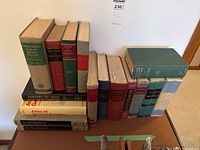 Side view showing a collection of vintage medical textbooks including titles on pathology, surgery, histology, pharmacology, and abdominal operations.
