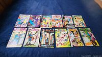 Display of 12 Superman's Girl Lois Lane comics laid out in two rows showing covers and condition.