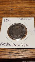 Front side of the 1861 Nova Scotia one cent coin showing a crown and date 1861 with 'NOVA SCOTIA' and 'ONE CENT' inscriptions.