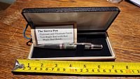 Sierra pen in case with measuring tape showing length about 5.5 inches
