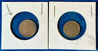 Front and back view of both coins in protective 2x2 cardboard holders on a blue background.