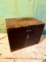 Front and top views of antique wooden toolbox showing latch and wear