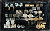 Full tray showing all cuff links arranged neatly on black velvet display tray