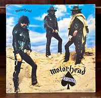 Front cover of Motorhead Ace of Spades vinyl LP showing band members in leather outfits standing on rocks.