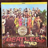 Front cover of the LP album showing iconic Sgt. Pepper's Lonely Hearts Club Band artwork with many people and floral lettering spelling 'Beatles'