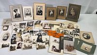 Overview of entire collection showing framed and loose vintage photographs with sepia and black-white tones.