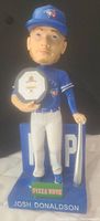 Front view of Josh Donaldson bobblehead in Blue Jays uniform holding MVP plaque and bat resting on ground.