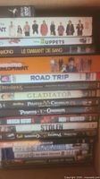 Photo showing a stack of DVDs with titles such as Arrested Development, The Muppets, Blood Diamond, Gladiator, Pirates of the Caribbean, Lord of the Rings, American History X, Road Trip.
