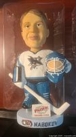 Front view of NHL San Jose Sharks Nabokov bobblehead in original packaging showing figure holding goalie stick and mask, with visible logos and base text.