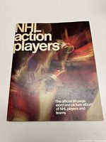 Photo of front cover of the sticker album showing 'NHL action players' text and blurred hockey player image.