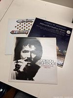 Photo shows three vinyl LP records: Gordon Lightfoot Summertime Dream, Hollywood Bowl Symphony Orchestra Strings by Starlight, and Max Webster albums.
