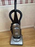 Front view of Samsung Quiet Jet vacuum cleaner showing Quiet Jet branding and power brush controls.