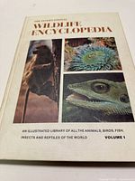 Front cover of Volume 1 showing title text and images of a bird, sea anemone, and reptile head.