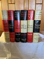 Front view of six volumes in dust jackets lined up on shelf: The Gathering Storm, Their Finest Hour, The Grand Alliance, The Hinge of Fate, Closing the Ring, Triumph and Tragedy
