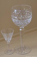 One wine goblet and one liqueur glass side by side showing scale and pattern