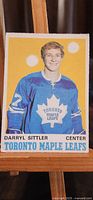 Front side of Darryl Sittler rookie hockey card showing him in Toronto Maple Leafs uniform with card title and player position.