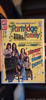 Front cover showing the full comic book with The Partridge Family sitting and standing, colorful text and graphics including 'Menace in the Moonlight' and 'Fanged Death Stalked Chris and Tracy'.