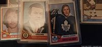 Three rookie cards: Bob Gainey, Don Cherry, Börje Salming in protective sleeves