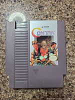 Photo of 1988 Contra Nintendo NES cartridge, showing front label and overall condition.