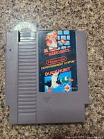 Front view of Nintendo NES game cartridge featuring Super Mario Bros. and Duck Hunt label.