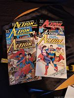 Six Superman-themed comic books displayed fanned out showing colorful covers and characters.