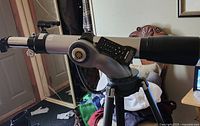 Gray Meade telescope main optical tube mounted in a fork head with remote control attached