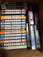 Photo of stacked Diary of a Wimpy Kid books showing multiple volumes with colored spine bands and title visible.