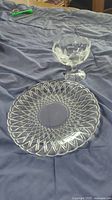 Photo showing clear glass bowl with scalloped edge and pedestal, and clear glass tray with woven pattern on edge