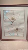 Front view of framed floral wall art with lily print and wooden frame